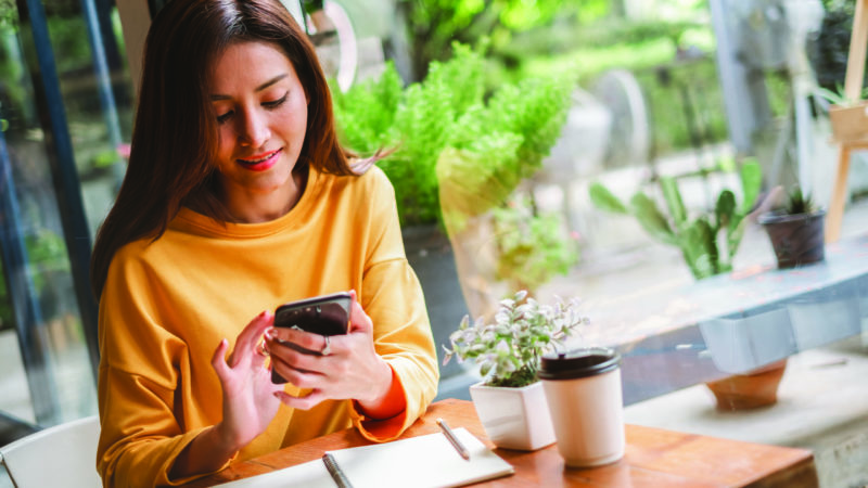 Woman on her phone in a cafe