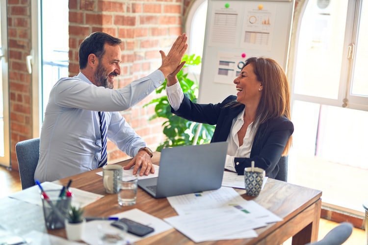 two business owners high-fiving