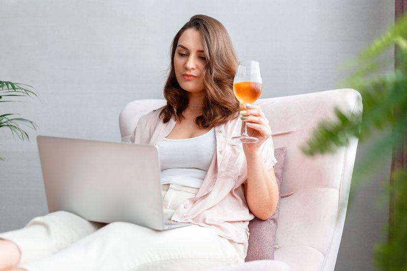 businesswoman with laptop in virtual wine tasting for B2B eCommerce Solutions