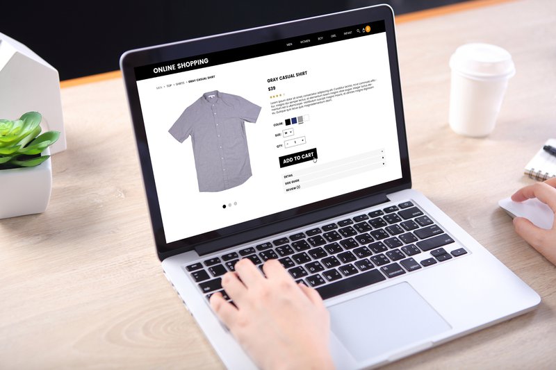 person shopping online for a gray shirt